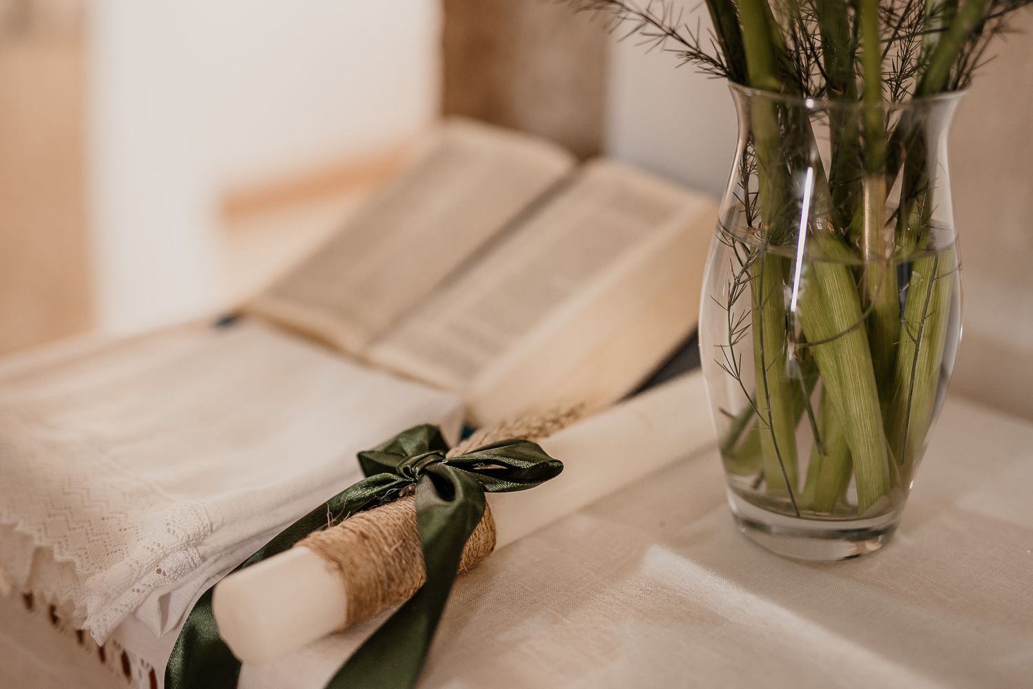 Wooden keepsake box with acrylic lid engraved with baptism details placed on a bedside table next to a warm lamp.