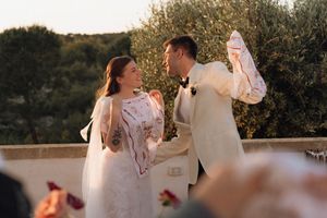 Bride and groom sharing a joyful moment during outdoor wedding ceremony at golden hour.