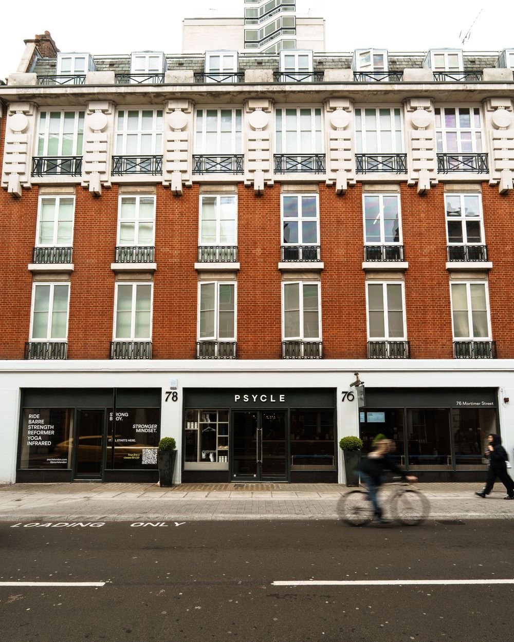 Psycle fitness studio at 78 Mortimer Street, London, in a classic red brick building with ornate white detailing.