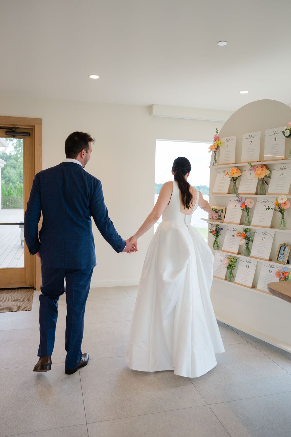 A series of photos showing a couple in wedding attire walking through a clean, bright room with wall-mounted photo shelves.