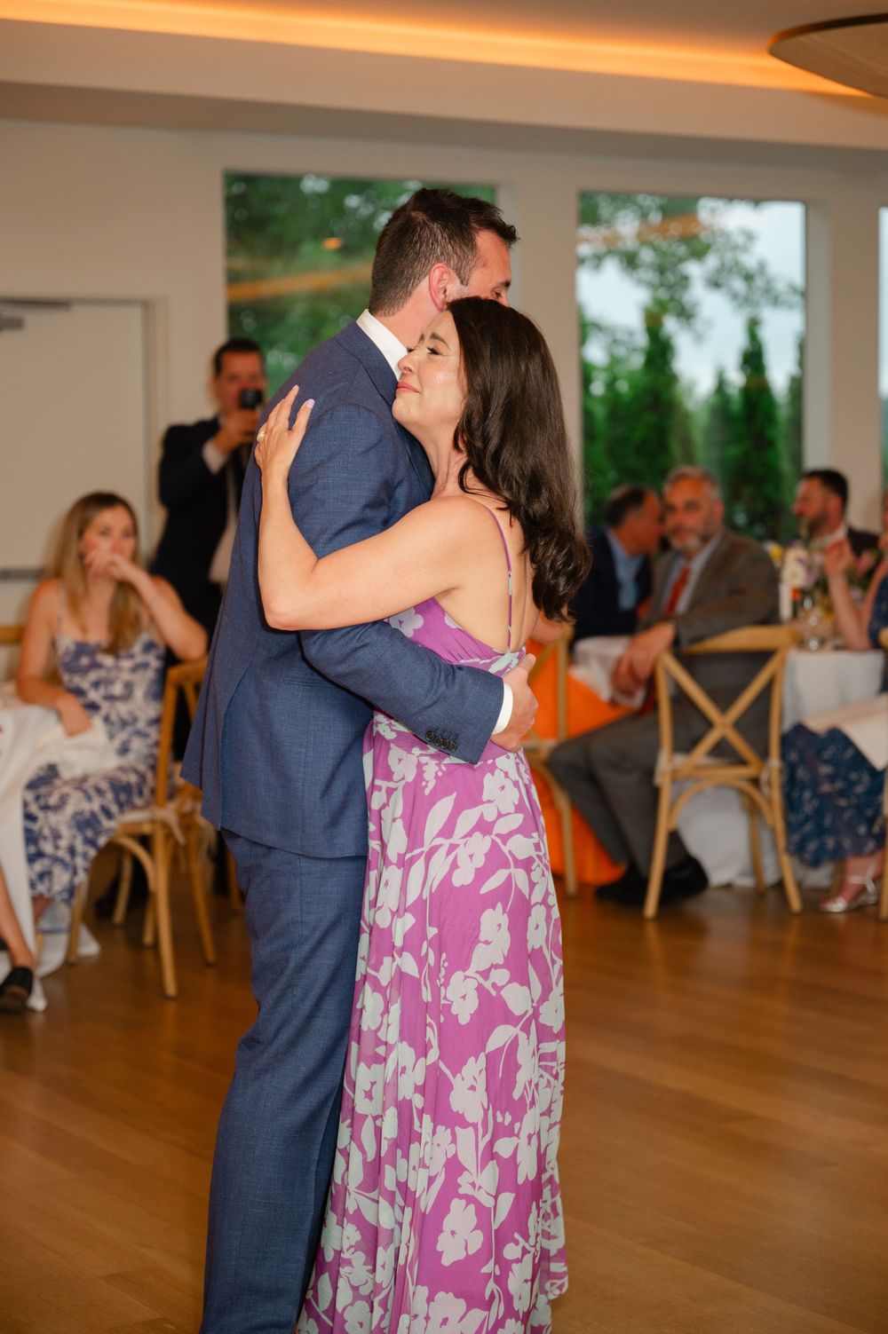 A mother-son dance is shared during a wedding reception.