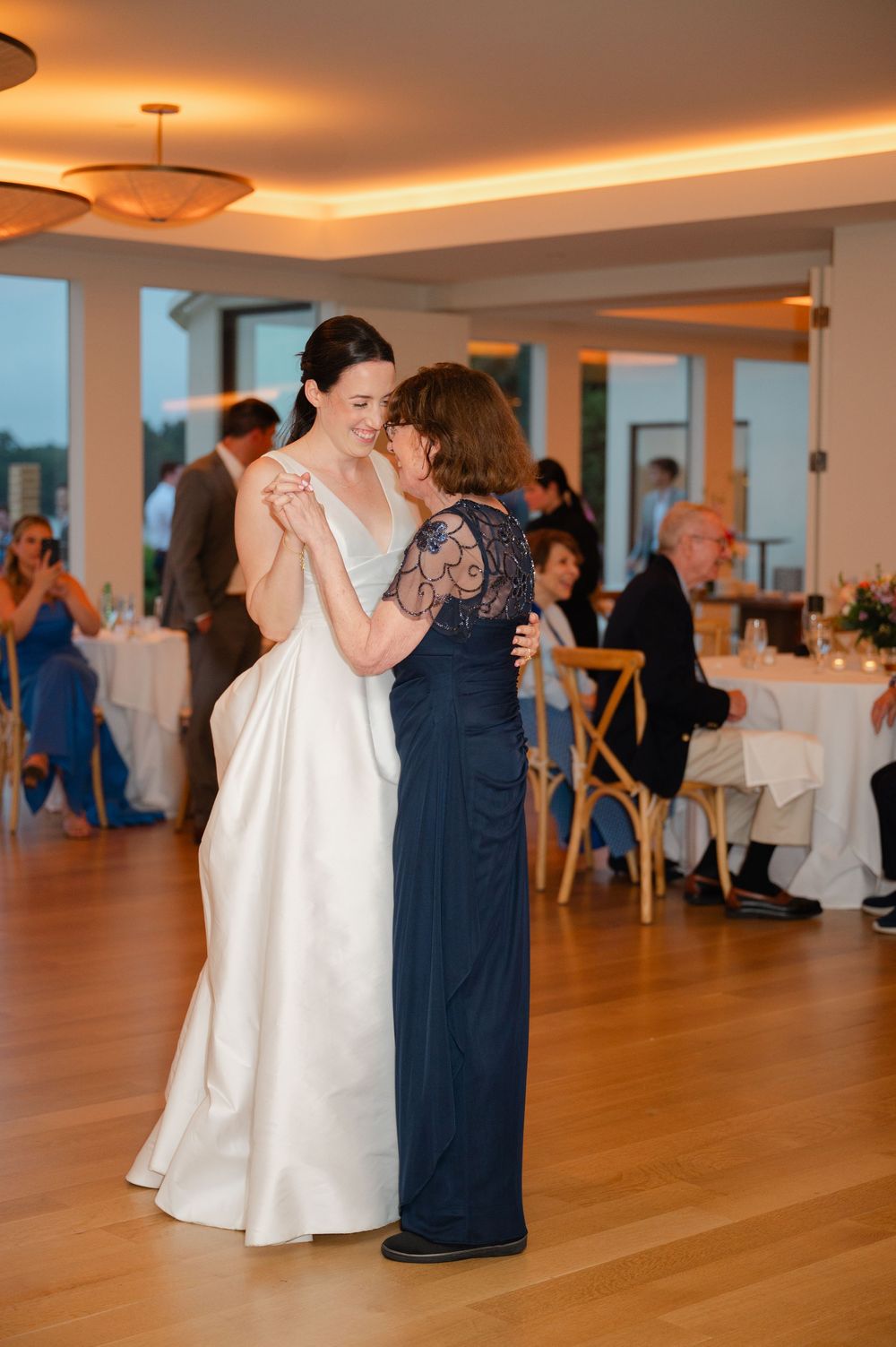 A bride surprises her mother with a special dance during a wedding reception at the Lakehouse in Massachusetts.