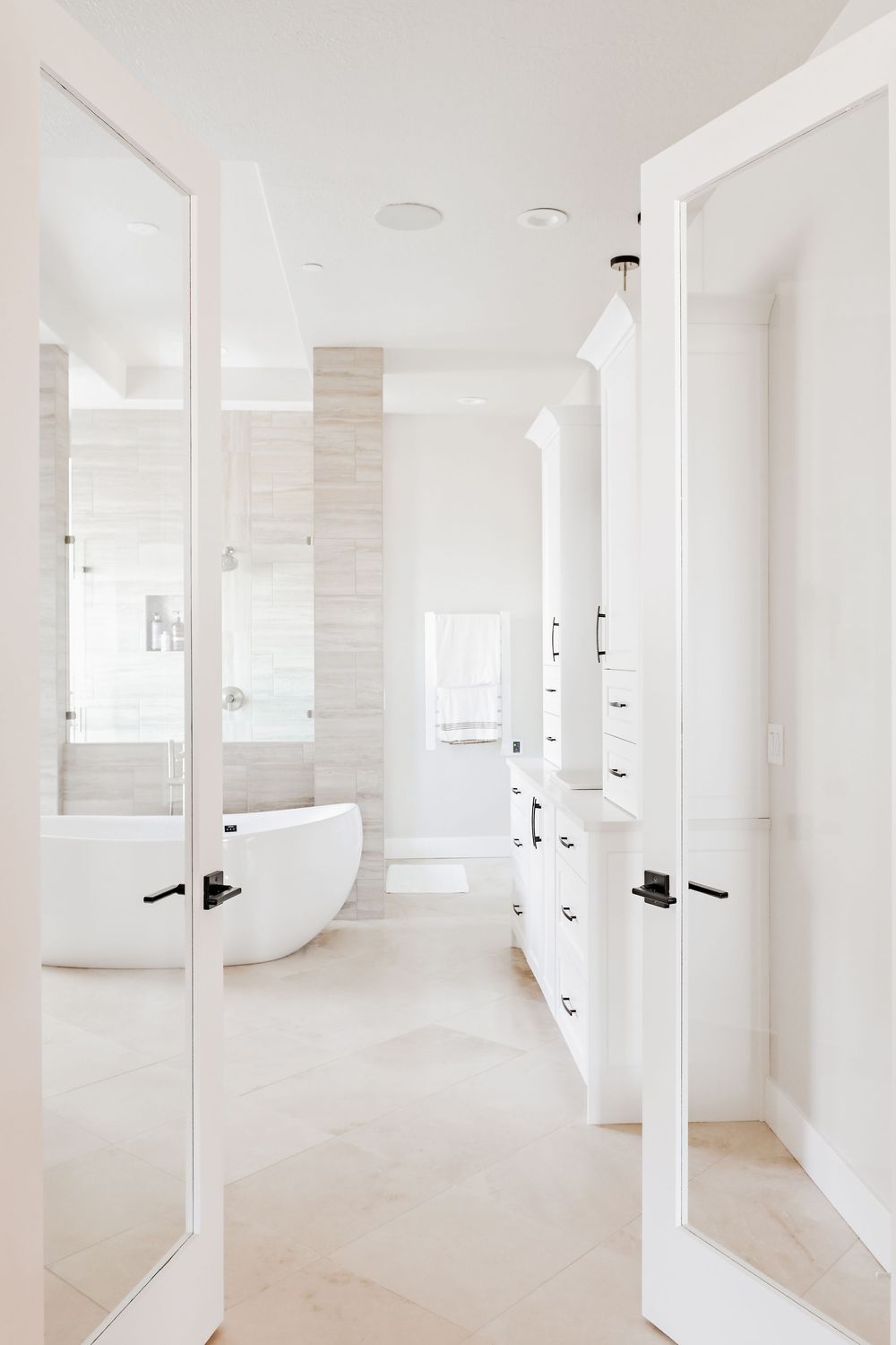 Bright white minimalist interior hallway with clean lines and sleek white doors.