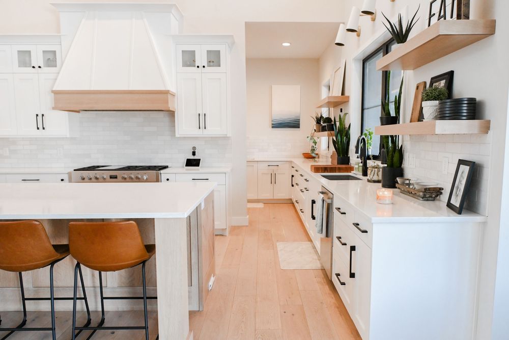 Contemporary open concept kitchen with peach-toned walls and white cabinetry.