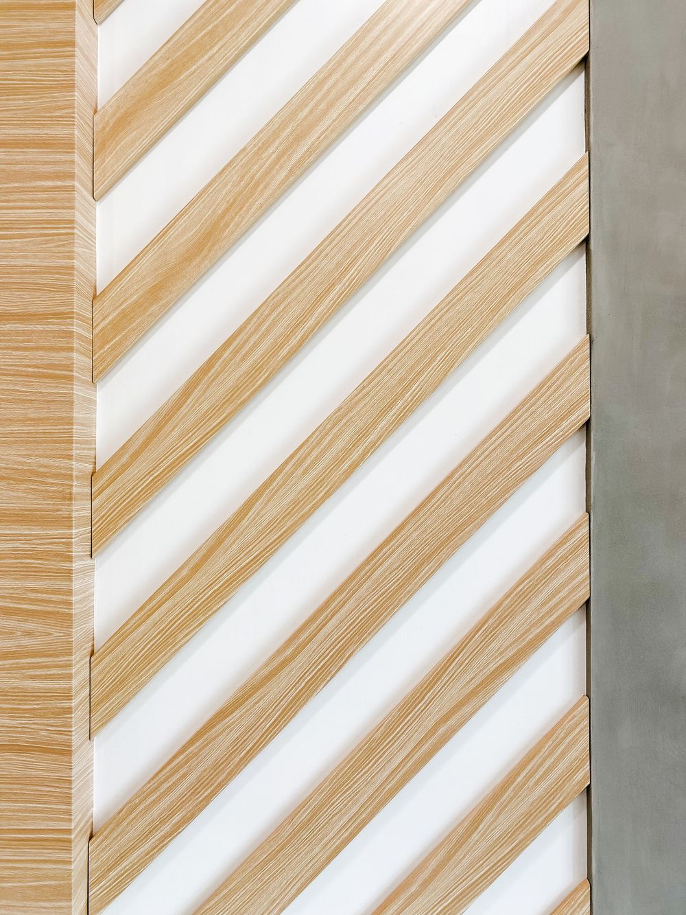 Diagonal striped wall pattern with alternating wood and white stripes creating modern aesthetic.