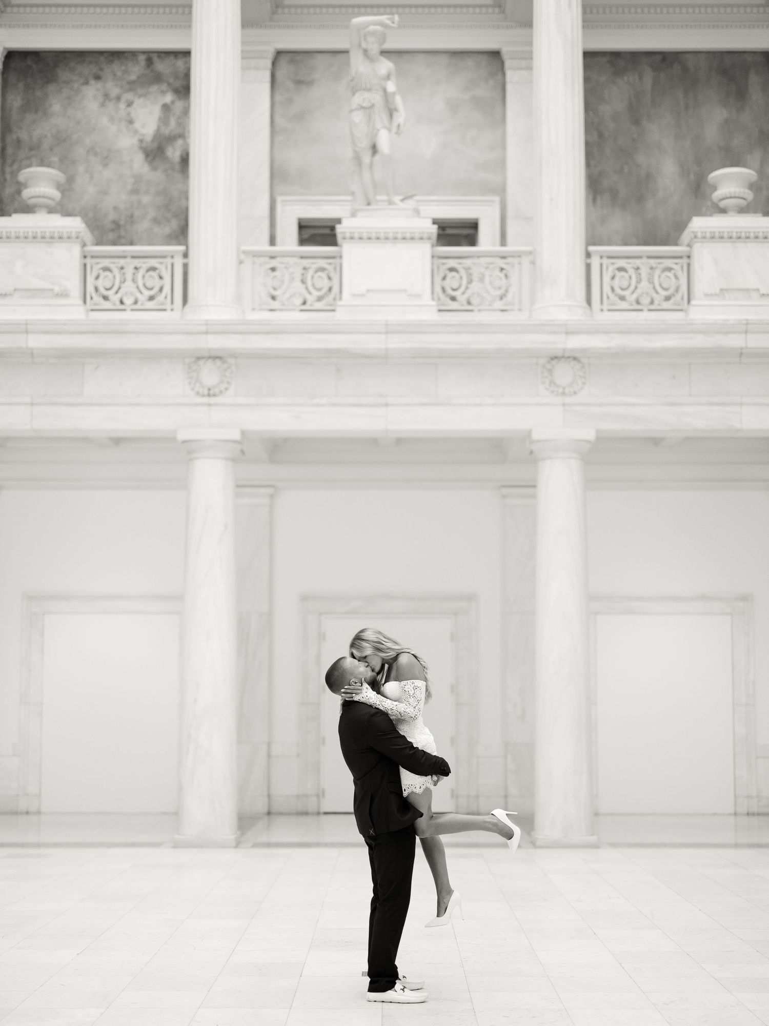 A sequence of black and white photographs showing a romantic couple dancing gracefully in an elegant classical setting.