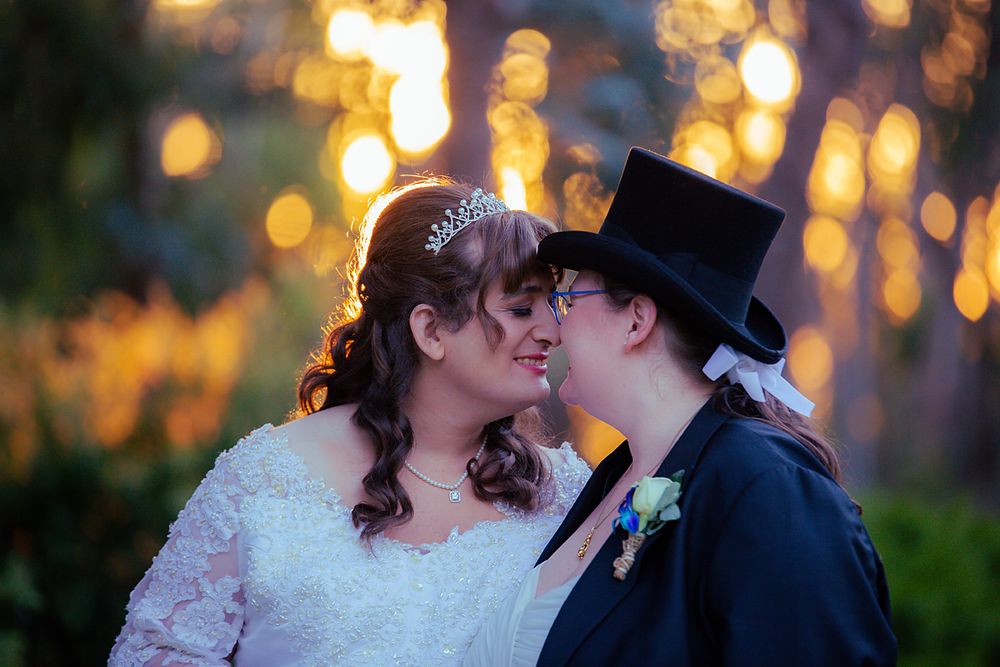 Golden sunset light illuminates tender intimate moments between newlyweds in an outdoor setting.