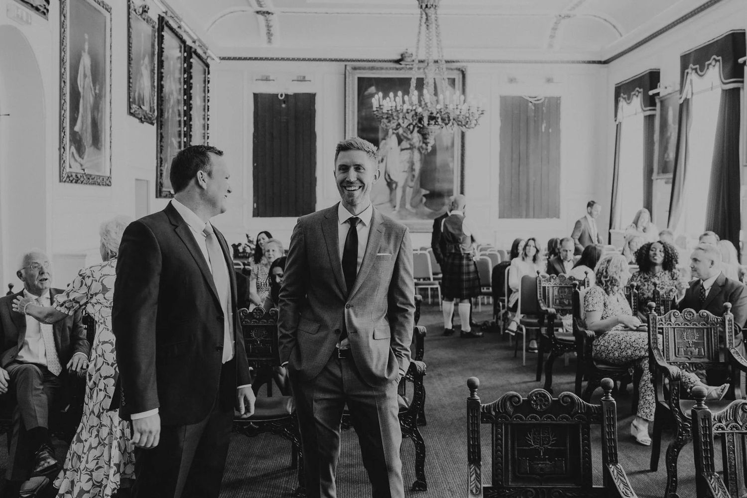 Elegant reception hall filled with guests in formal attire.