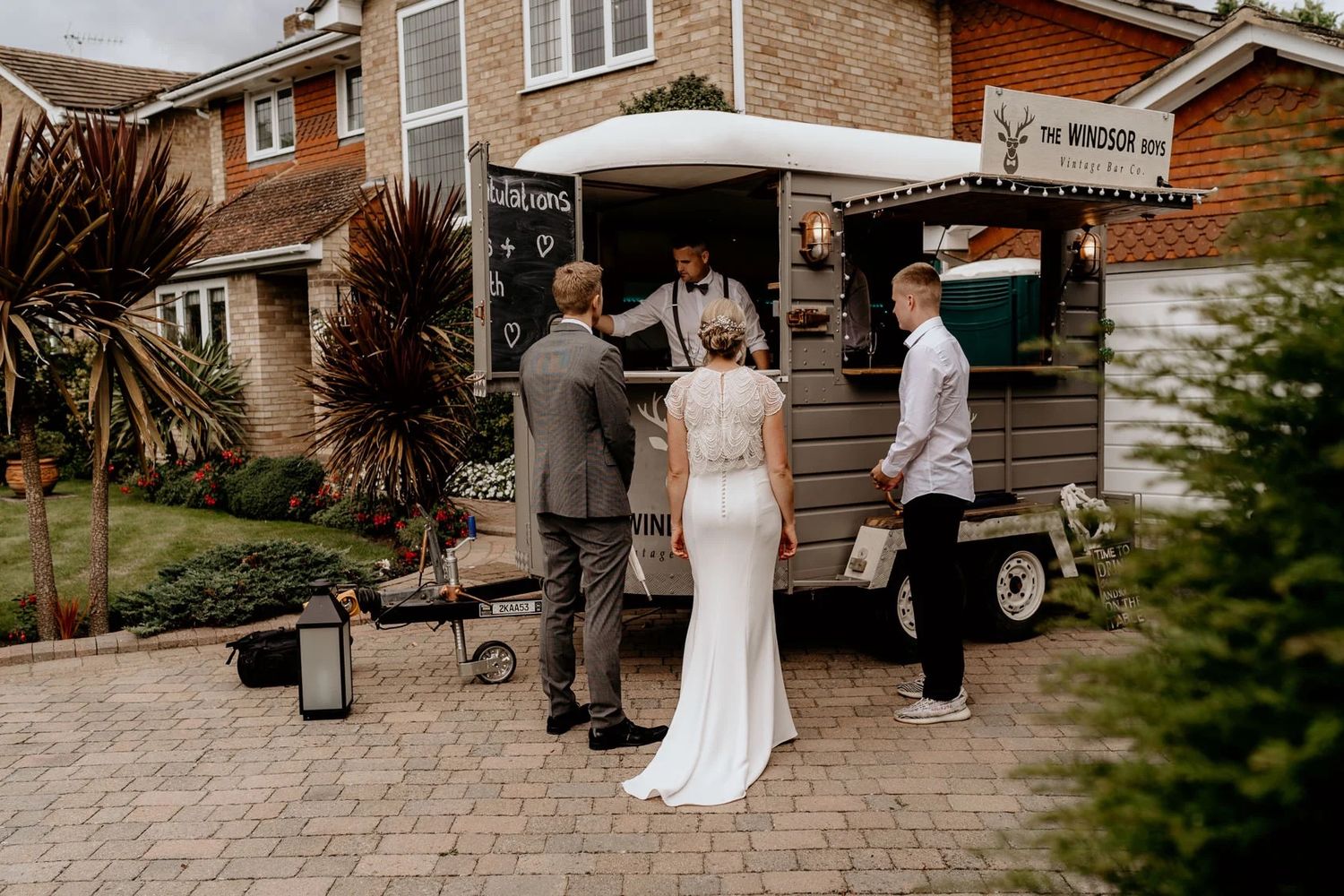 Nine side-by-side wedding ceremony moments showing a couple getting married in front of a rustic brick house backdrop.
