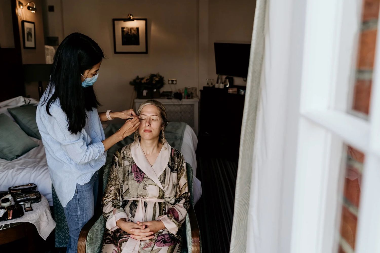 Getting ready scene in a room with soft natural window lighting.