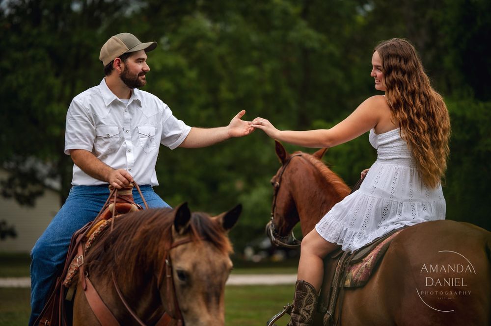A couple poses for romantic engagement photos with their horse in an outdoor setting during golden hour.