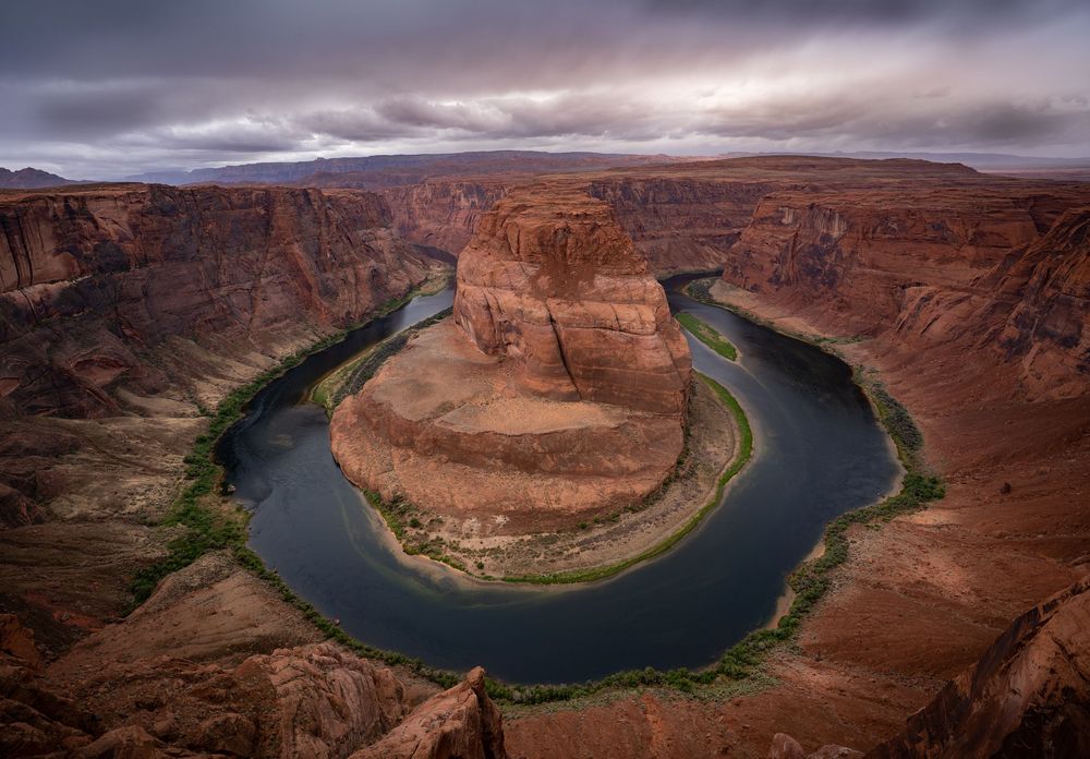 Dramatic aerial panorama of Horseshoe Bend on the Colorado River in Arizona showing the iconic curved canyon formation.