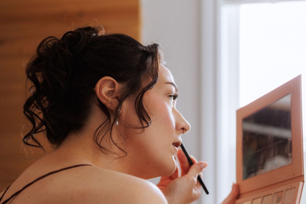 Bride getting ready at a Trinity Airbnb by Newfoundland documentary style wedding photographer Kaitlyn Yvette