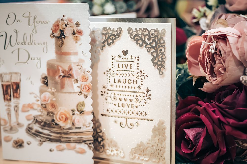 Elegant wedding invitation cards and decorative elements arranged with floral details in vintage sepia tones.