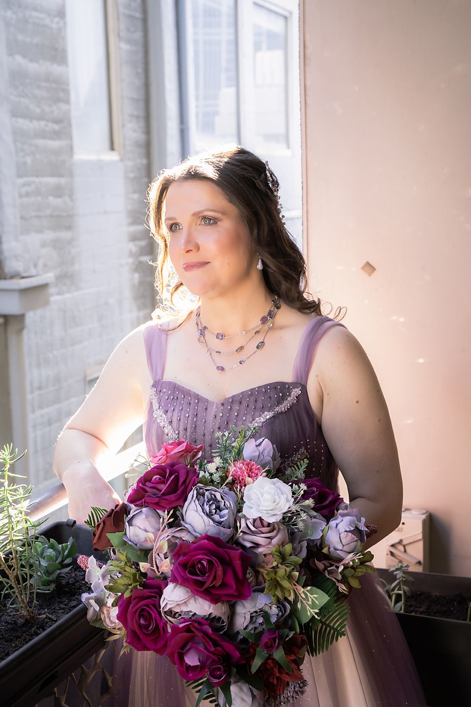 Four indoor bridal portraits showcasing a purple gown and vibrant burgundy and white floral bouquet.