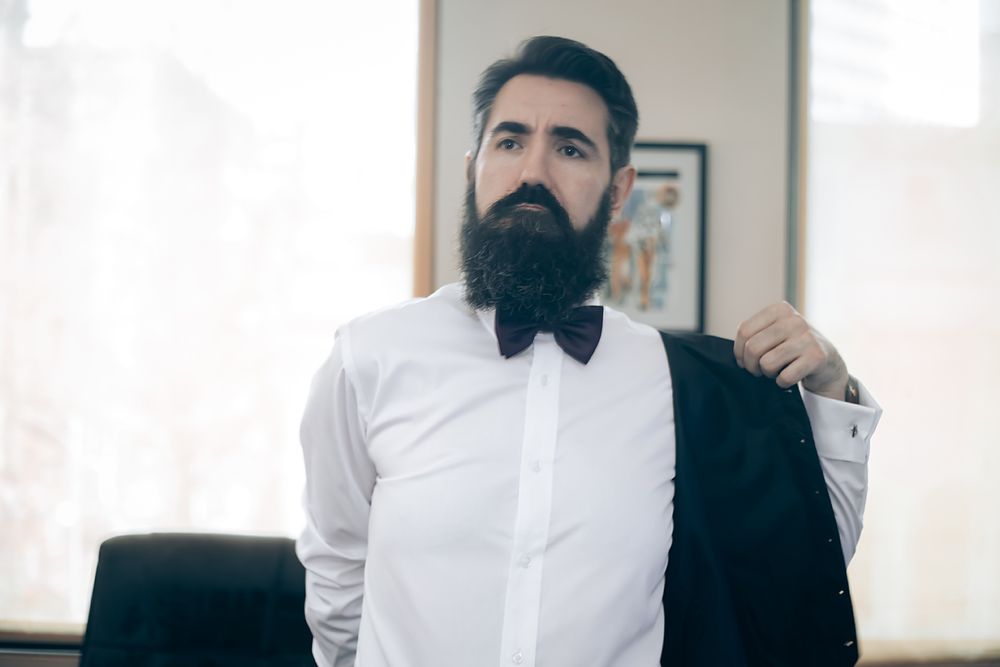 A series of candid shots showing a groom in formal attire with a black bowtie and white dress shirt.