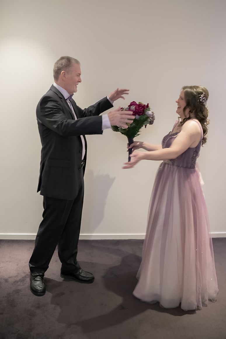 A sequence of photos shows a person in a dark suit offering flowers to someone wearing a light pink formal dress.