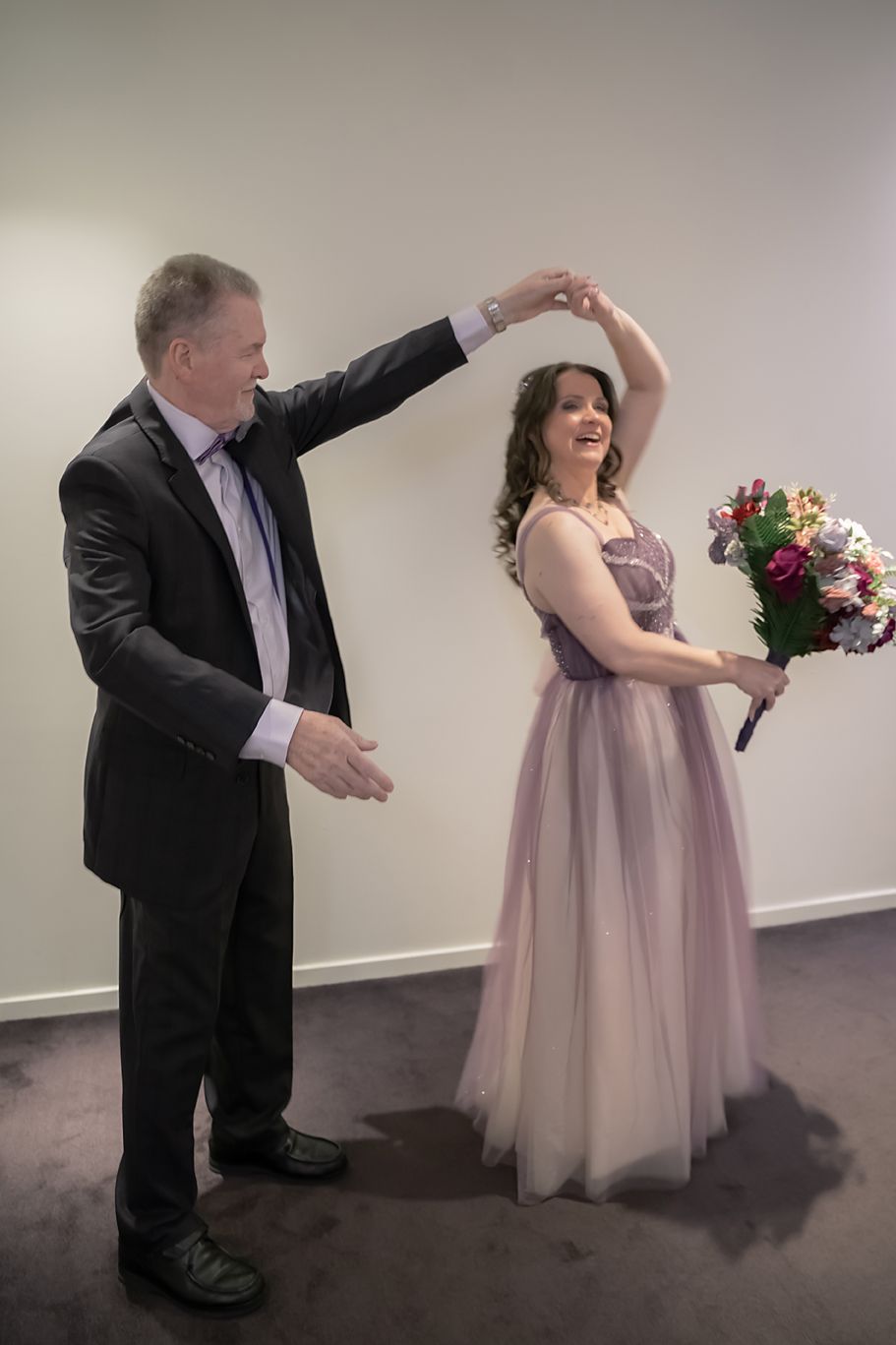 A series of photos showing a dance sequence between two people at a formal event, one in a pink dress and one in black.
