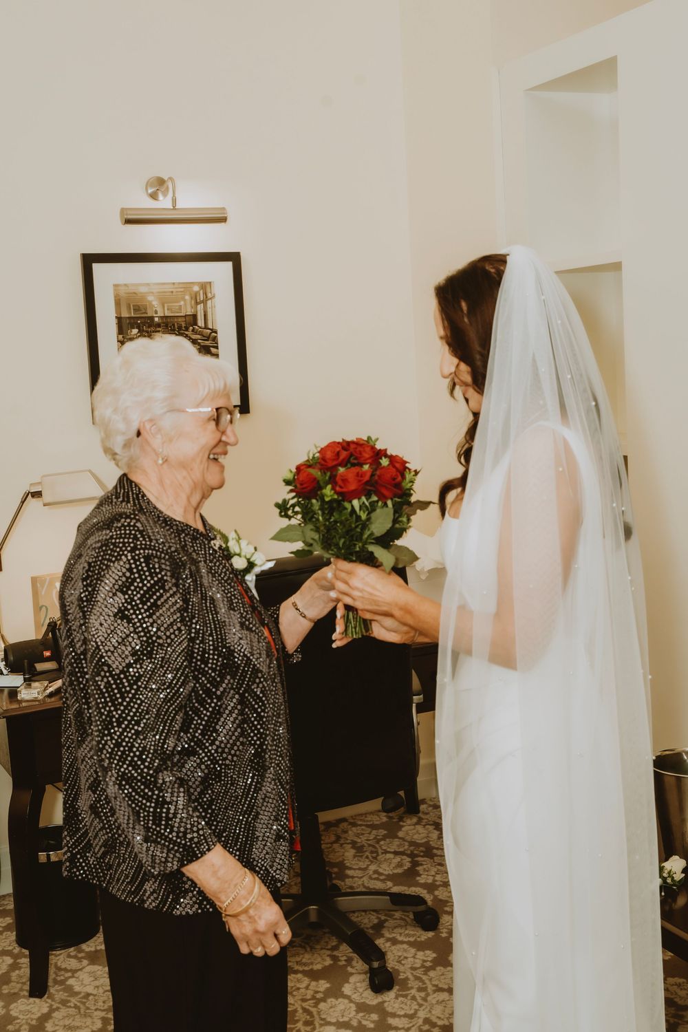A sequence of photos showing an emotional moment between a bride in white and an elderly woman in a dark patterned outfit.