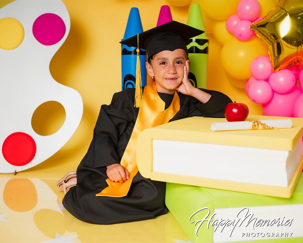 Creative graduation photography setup featuring colorful polka dots, balloons and school supplies.