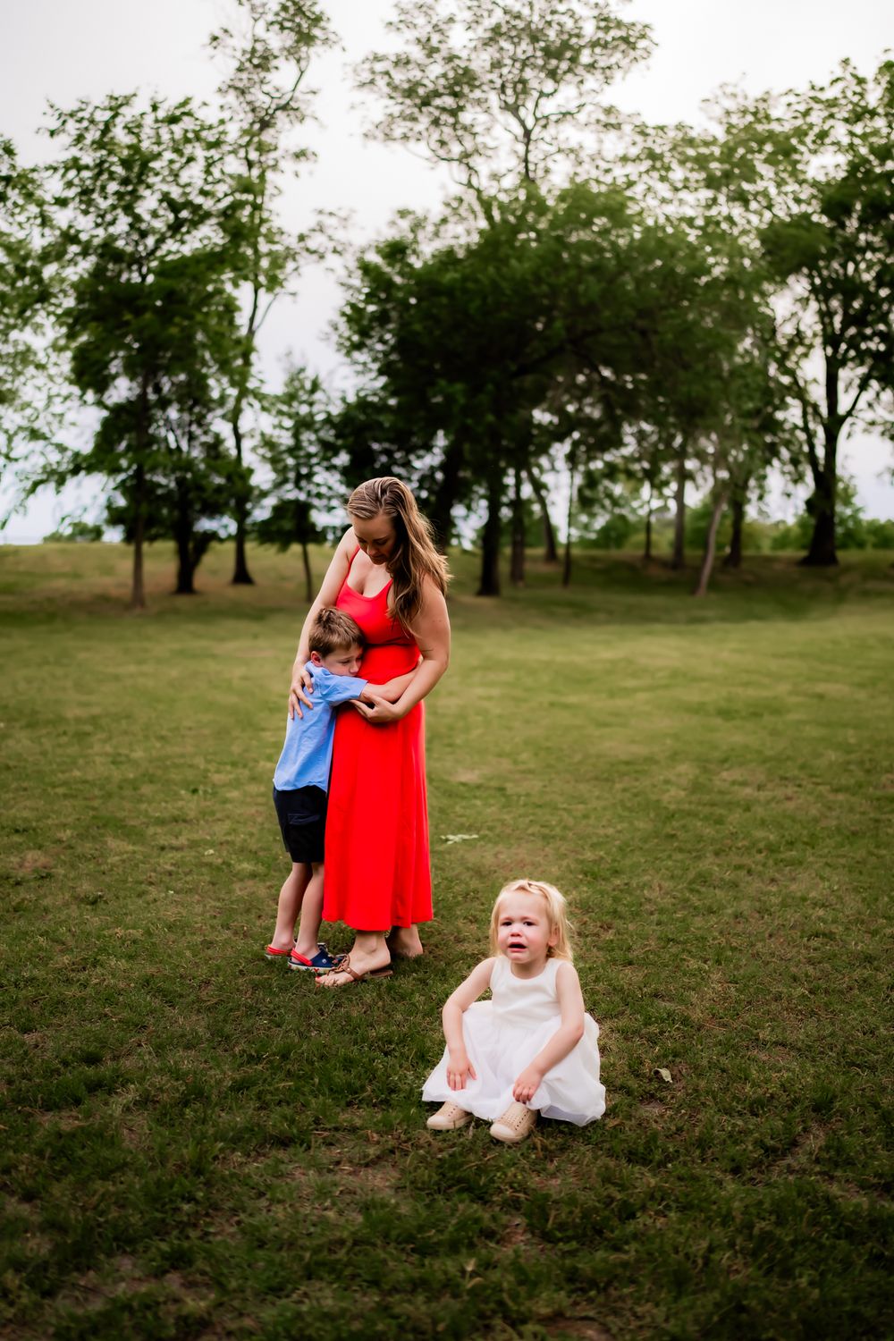 Joyful family moments captured in a series of candid outdoor photos on grassy field with trees in the background.