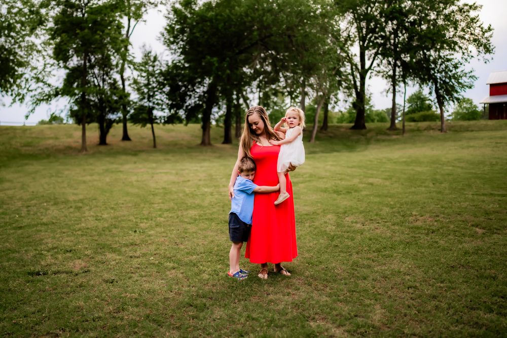 Children play in a grassy field while enjoying outdoor activities on a sunny day.
