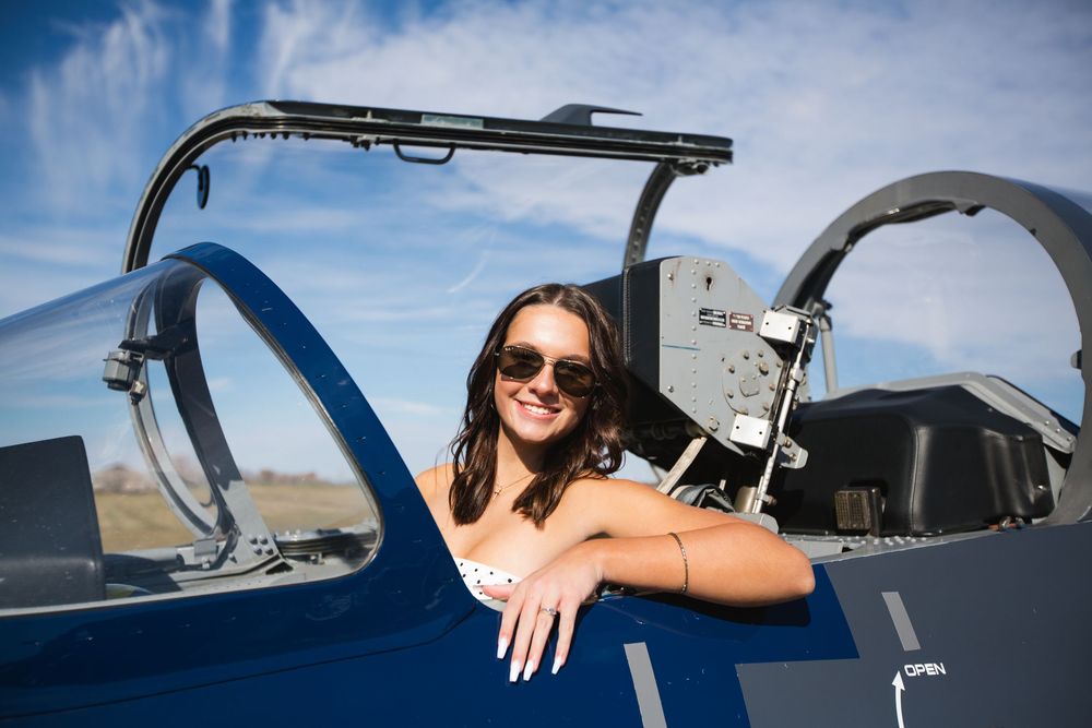 High school senior photo of girl in jet; aviation senior portrait session in Howell, Michigan by Brighton, MI photographer