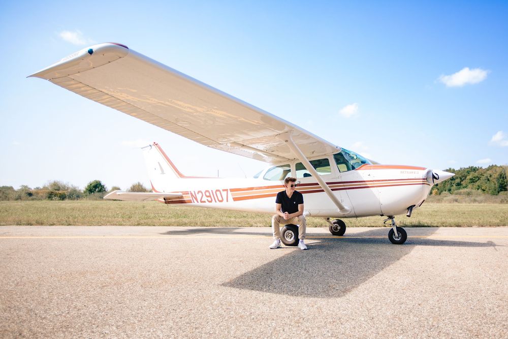 High school senior guy with plane; senior pilot, aviation portrait session by Brighton, Michigan photographer in Howell, MI