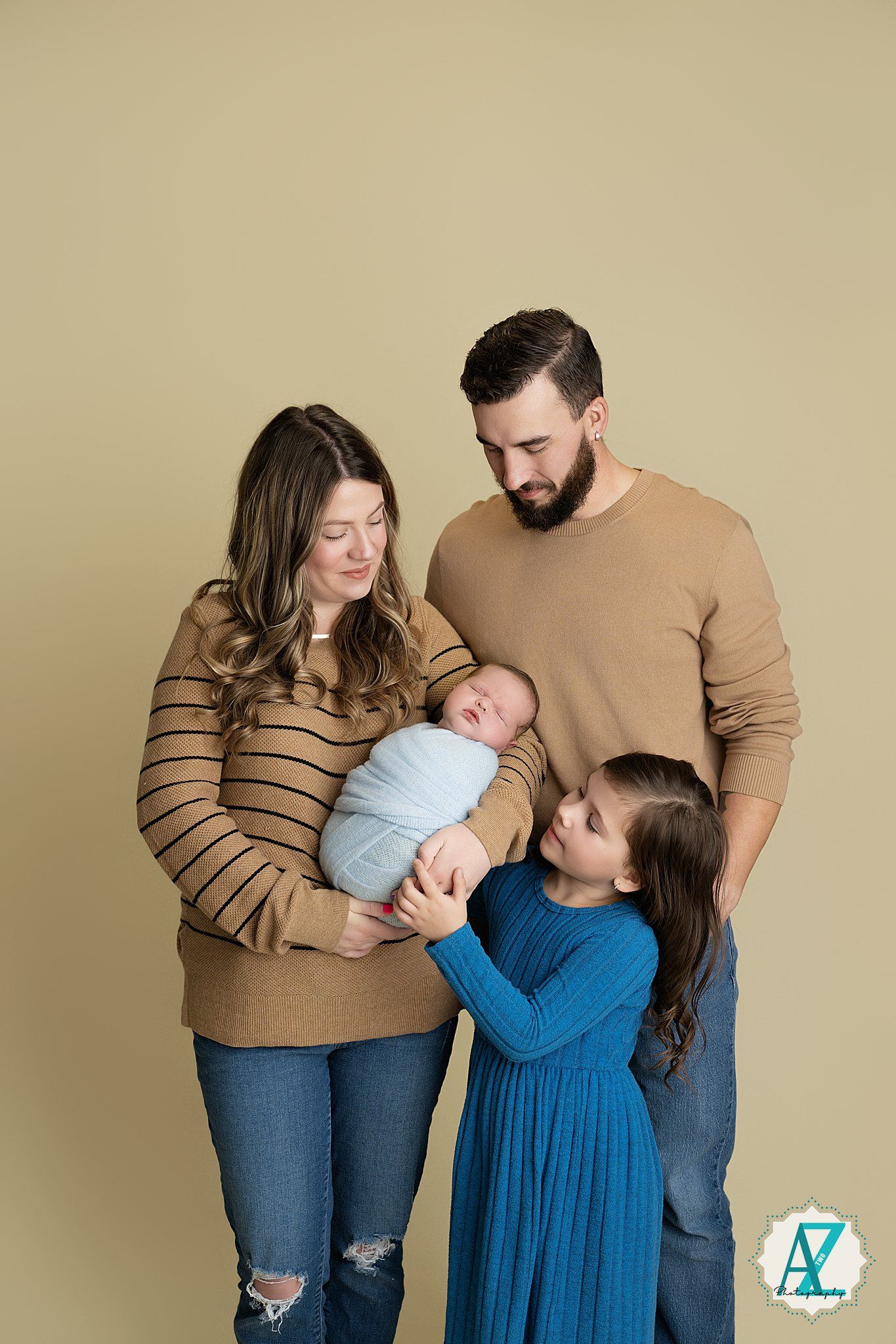 Family photoshoot series in complementary brown and blue outfits against neutral backdrop.