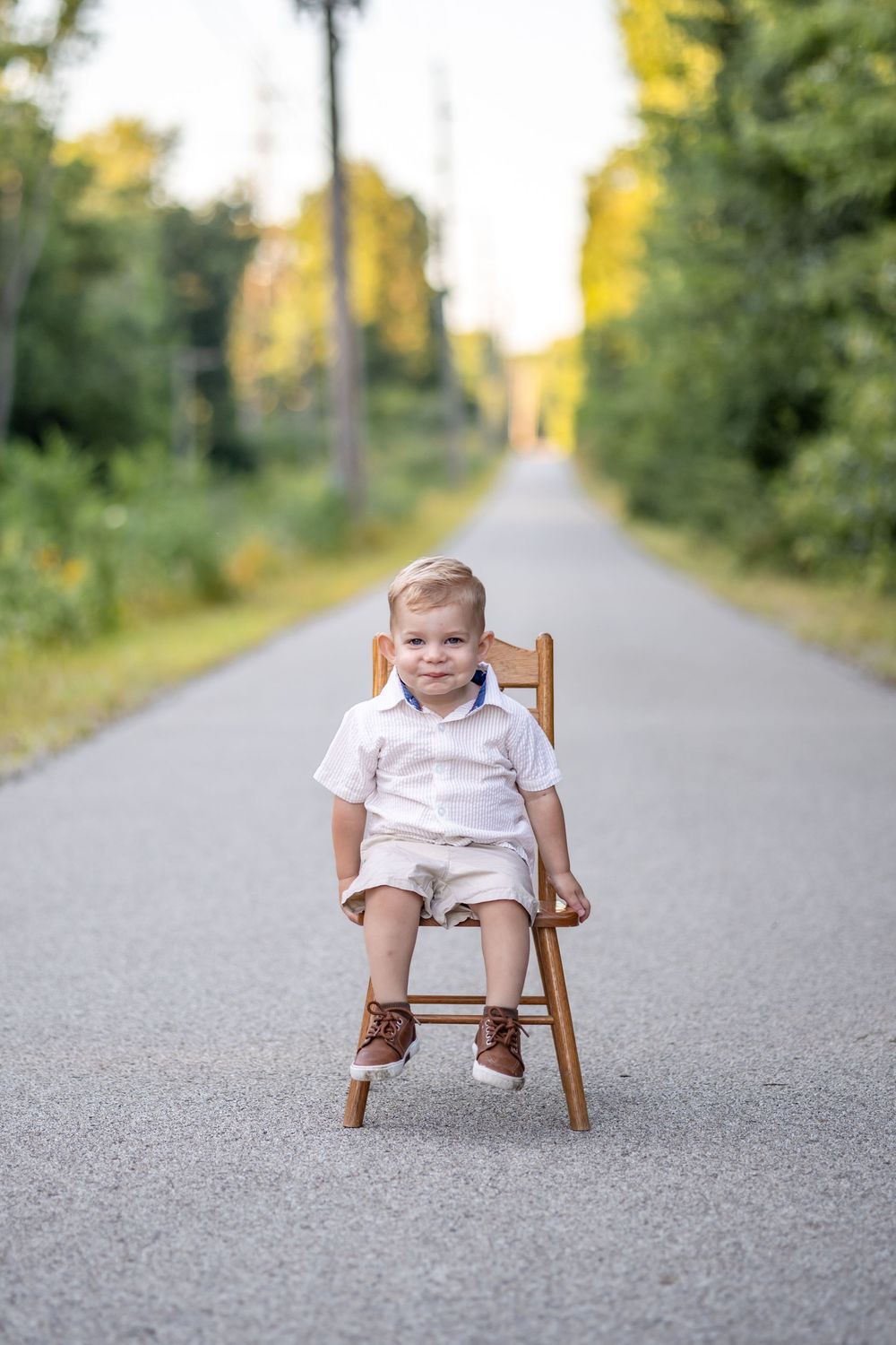 Springfield, IL Photographer captures a boy smiling while sitting on a chair during a session in Central IL