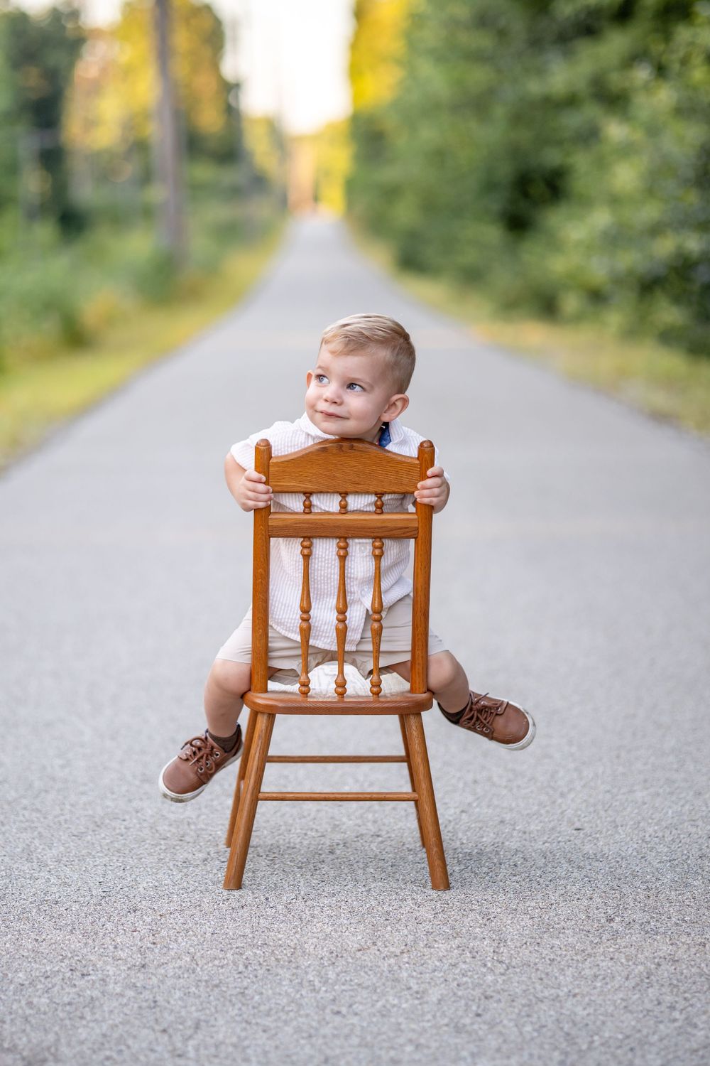 Springfield, IL Photographer captures a boy sitting and looking off smiling during a photo session in Central IL