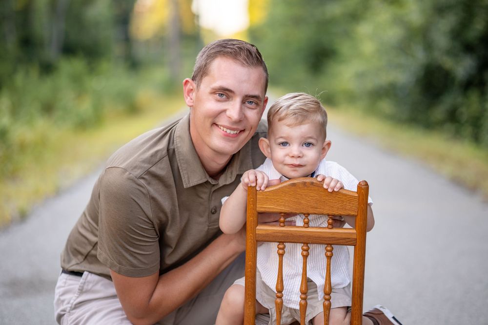 Springfield, IL Photographer captures a dad smiling with his son during a photo session in Central IL