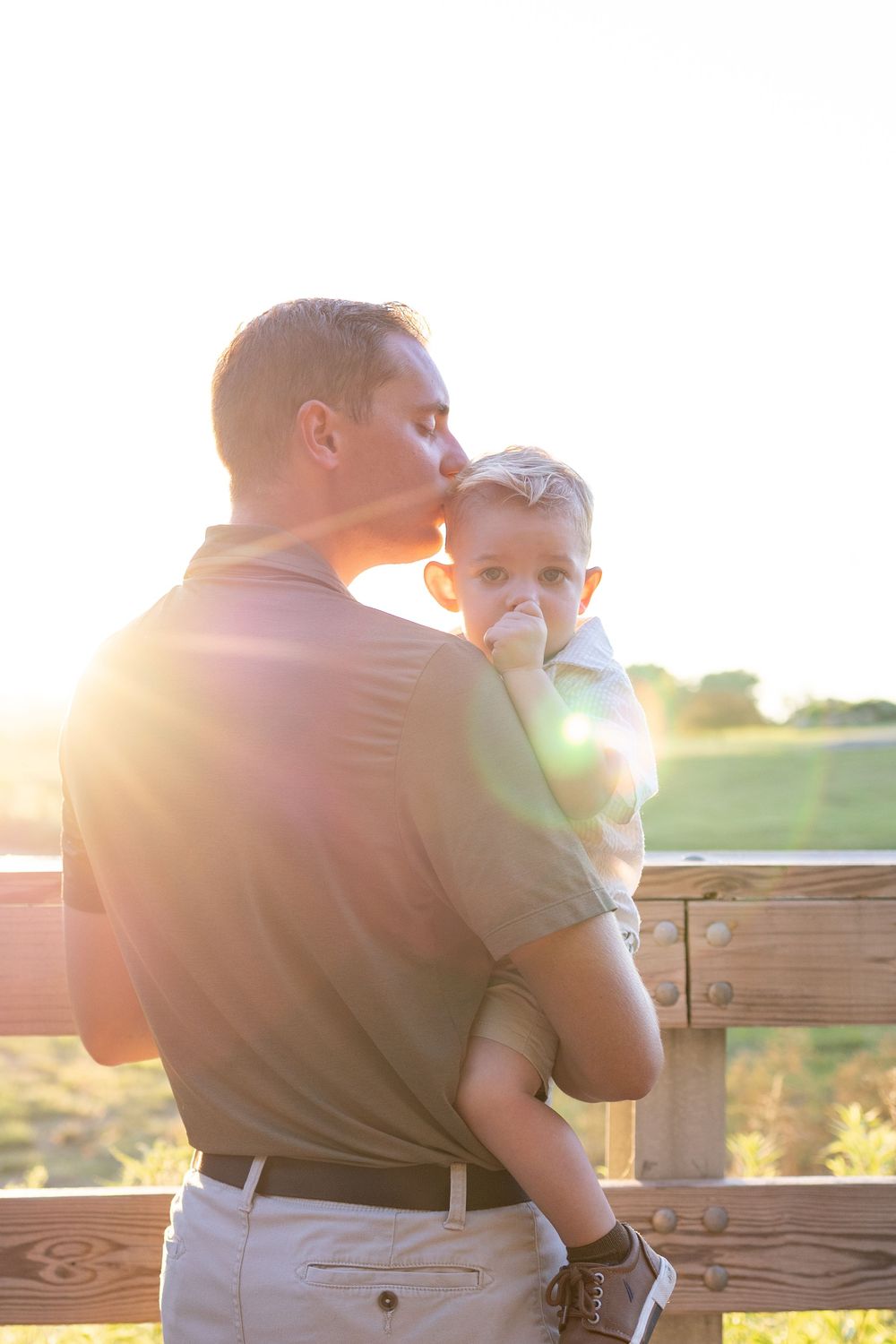 Springfield, IL Photographer captures a dad kissing his son's head during a session in Central IL