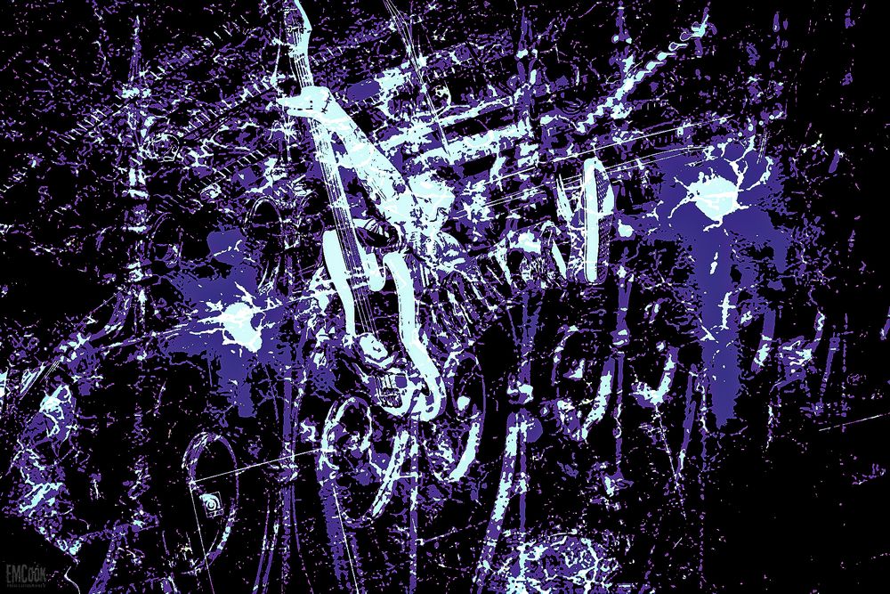 Abstract black and purple digital art pattern with scattered glowing elements against a dark background.