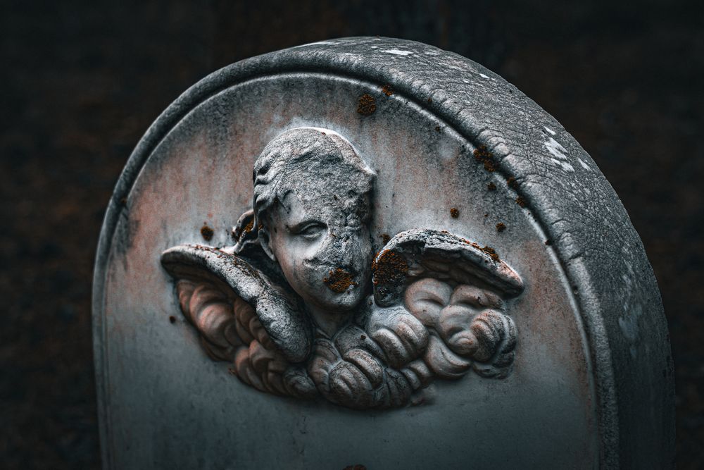 Close up detail of antique decorative metal casting with intricate sculptural relief patterns.
