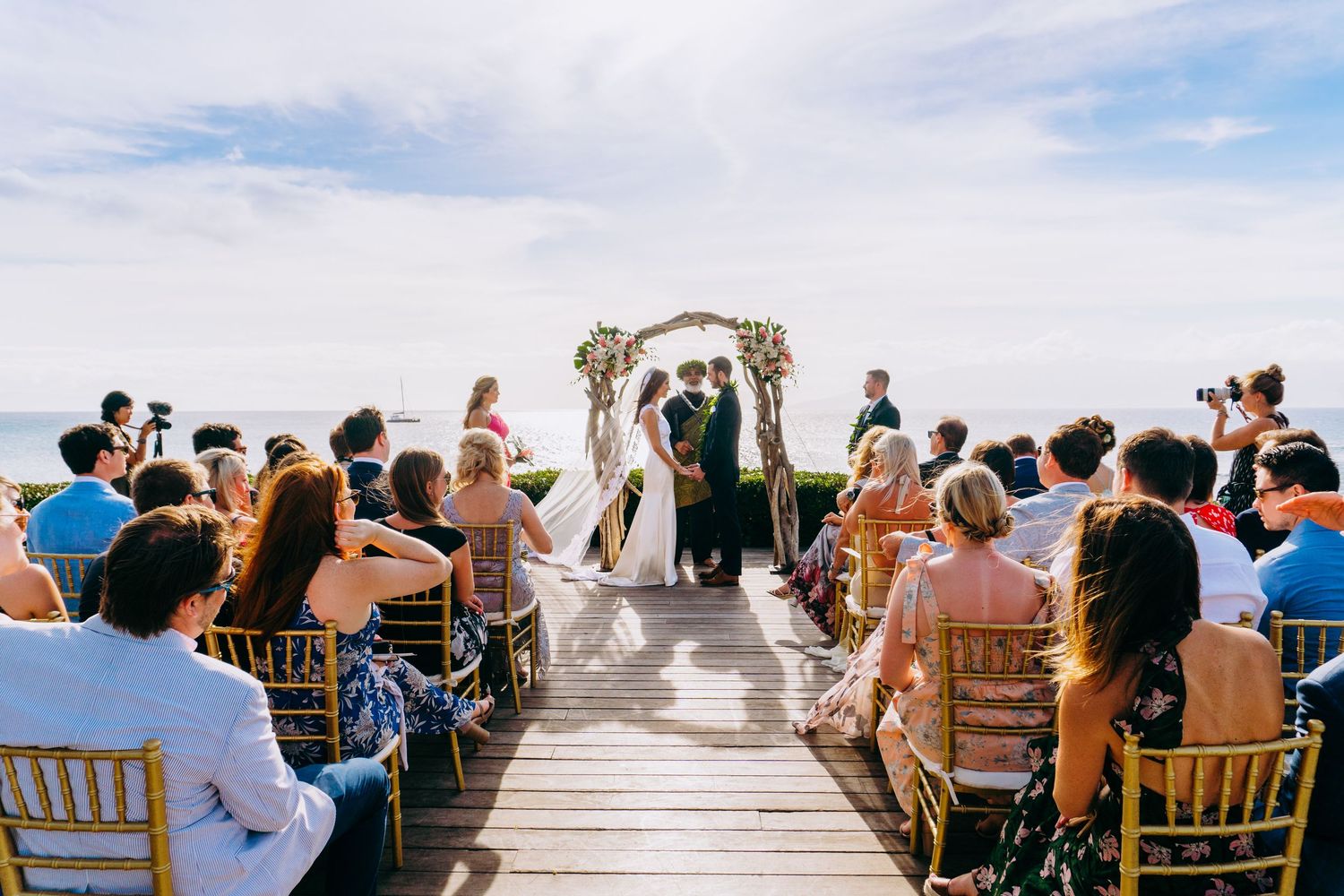 Wedding ceremony guests seated in wooden chairs overlooking ocean view. Maui Hawaii Kaanapali Kapalua Bay Merrimans wedding