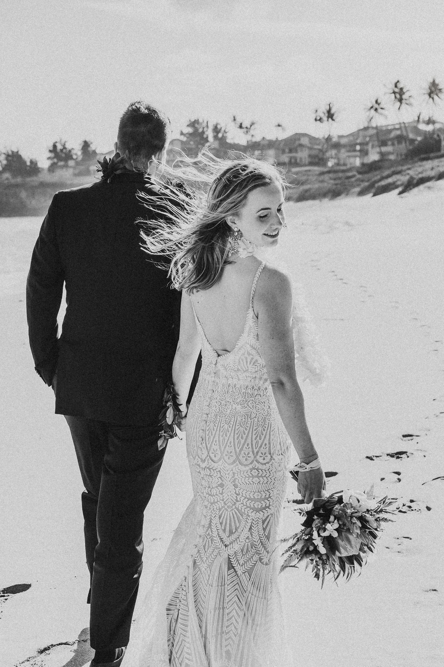 Black and white beach wedding photos with bride in lace dress and windswept hair.  Maui Hawaii wailea kihei makena beach wedding ceremony