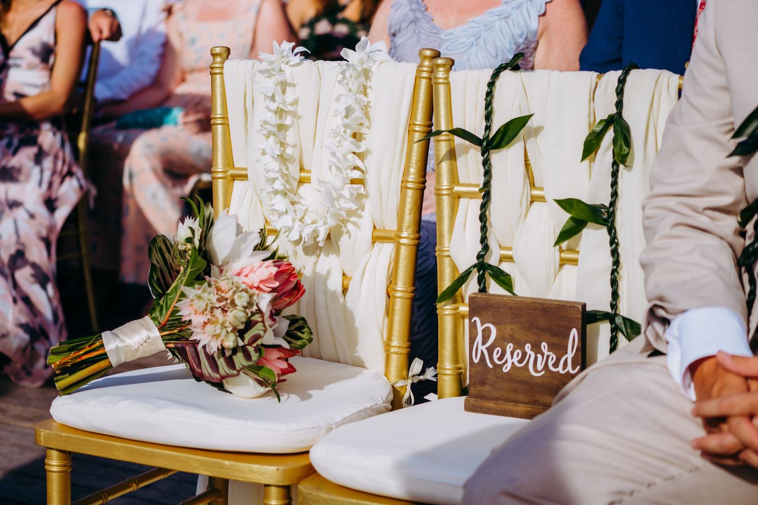 Elegant wedding ceremony setup with gold chairs and floral decorations in an indoor venue. Maui Hawaii Kaanapali Kapalua Merrimans wedding