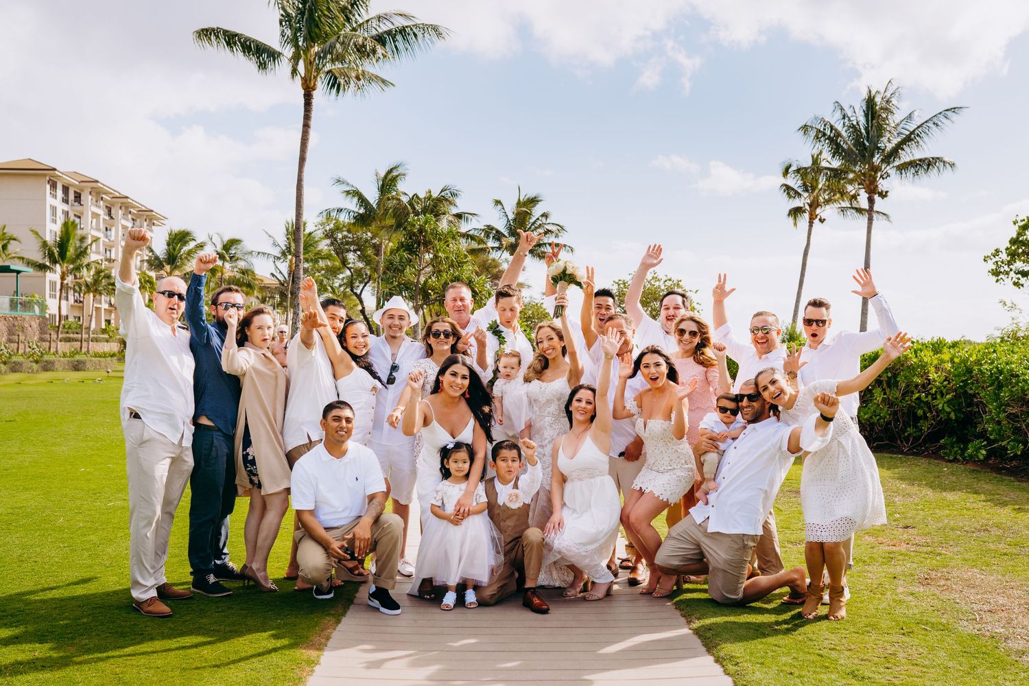 Wedding party dressed in white celebrates joyfully on a tropical beach with palm trees. Maui Hawaii kaanapali sheraton duke's hawaii photo