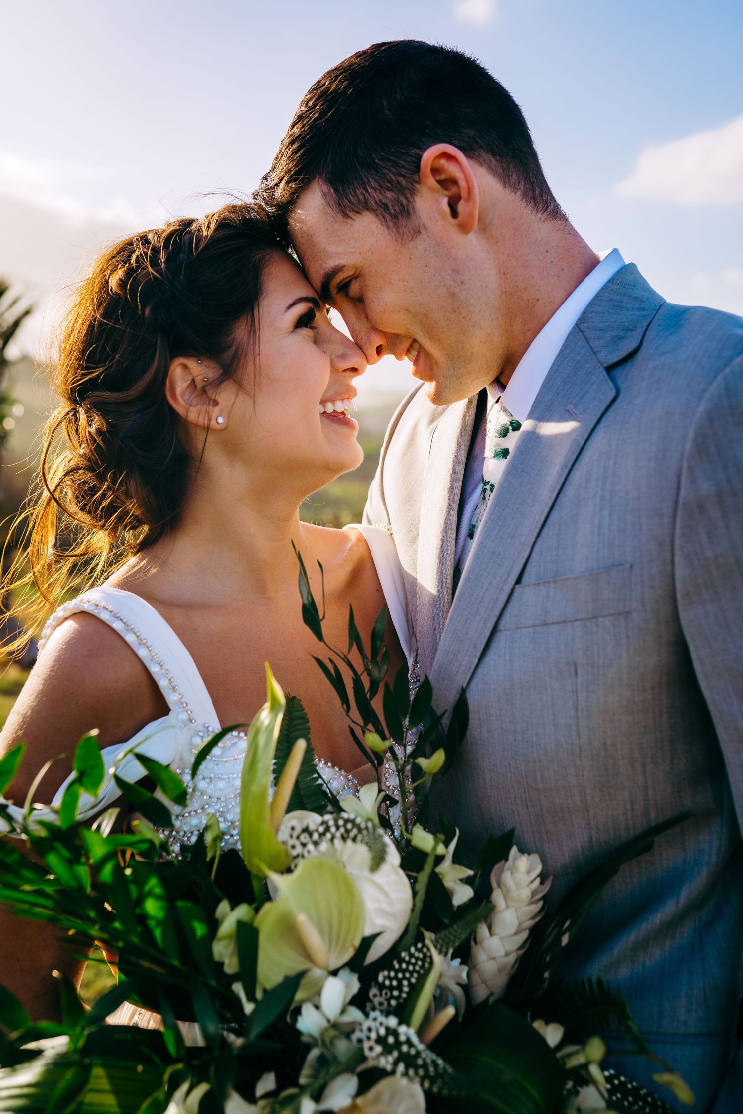 Intimate wedding portraits captured against a natural outdoor backdrop with white floral bouquet. Maui Hawaii Oahu Kaneohe Bay wedding