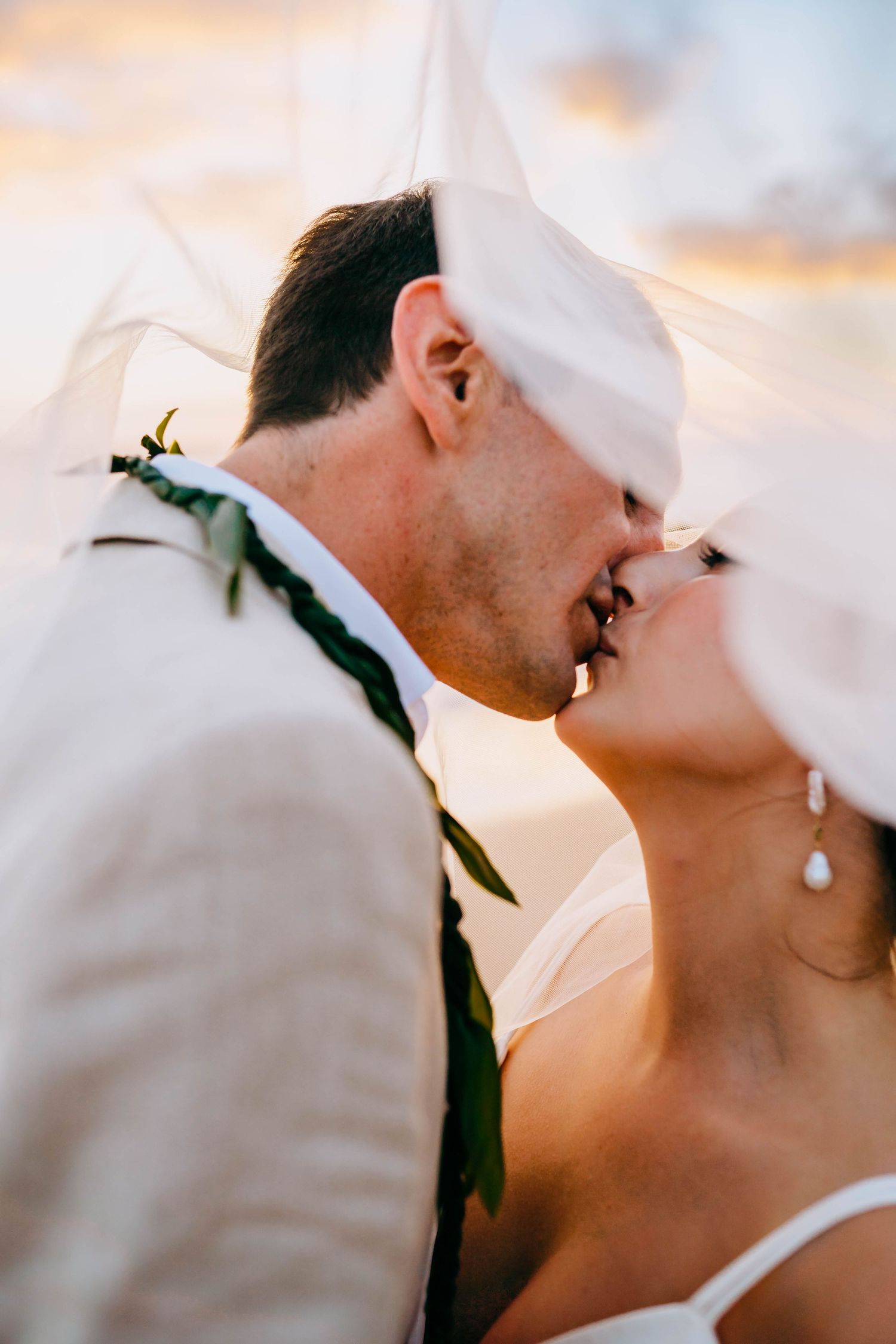 Intimate close-up of wedding couple sharing romantic moment at sunset. luxury destination wedding photos in wailea hawaii