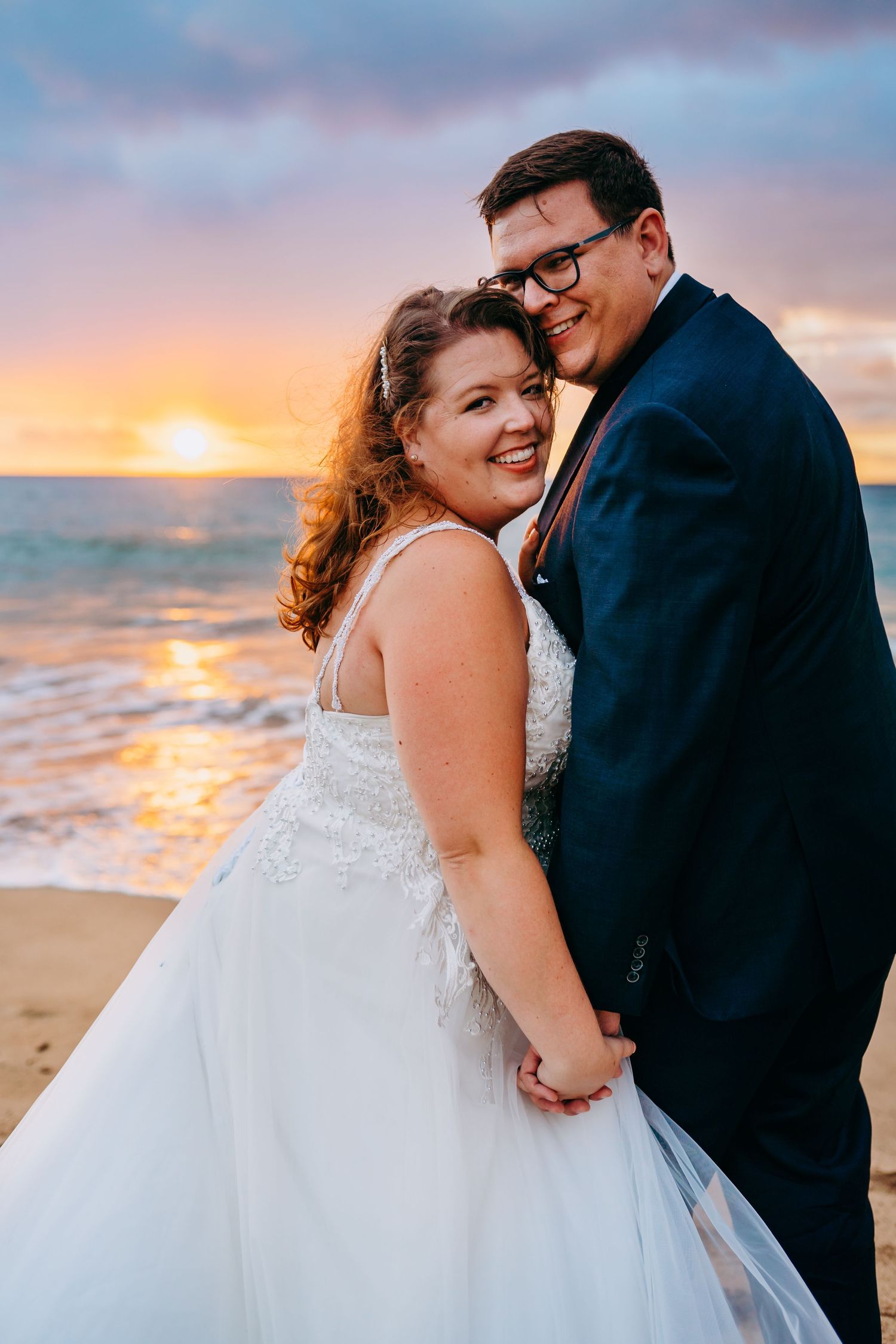 Intimate beach wedding for plus size bide captured in a close-up shot at golden hour. Maui Hawaii wailea kihei makena beach wedding ceremony