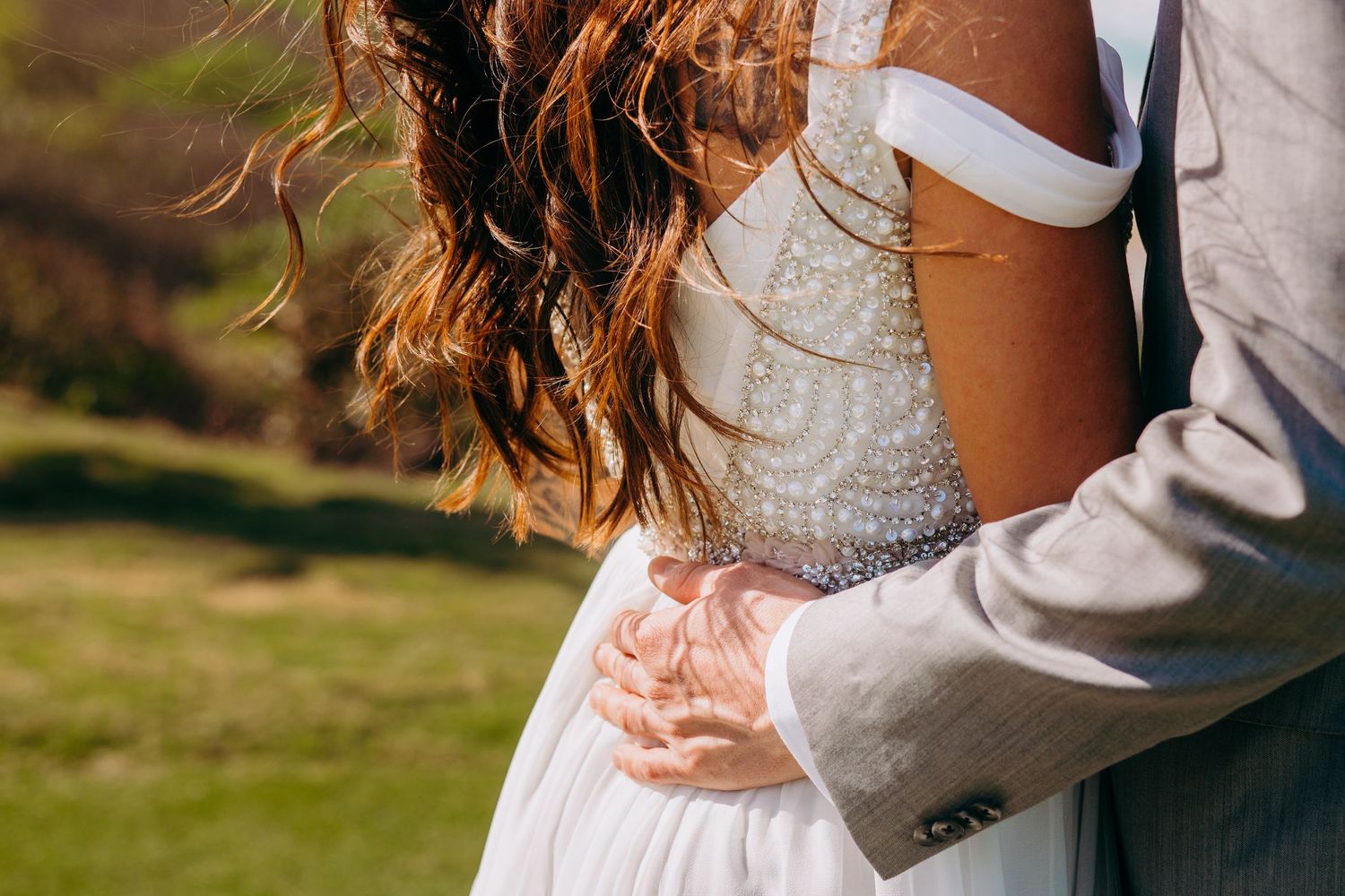 Romantic wedding couple embraces in soft natural lighting outdoors. Maui Hawaii Oahu Kaneohe Bay wedding military wedding beach