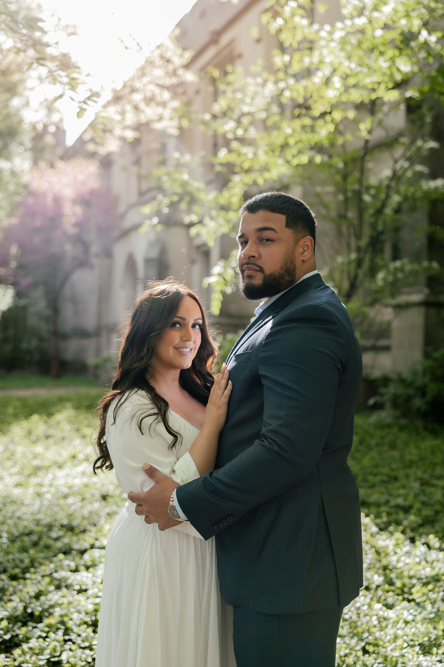 A romantic outdoor photoshoot in a blooming spring garden with white flowers.