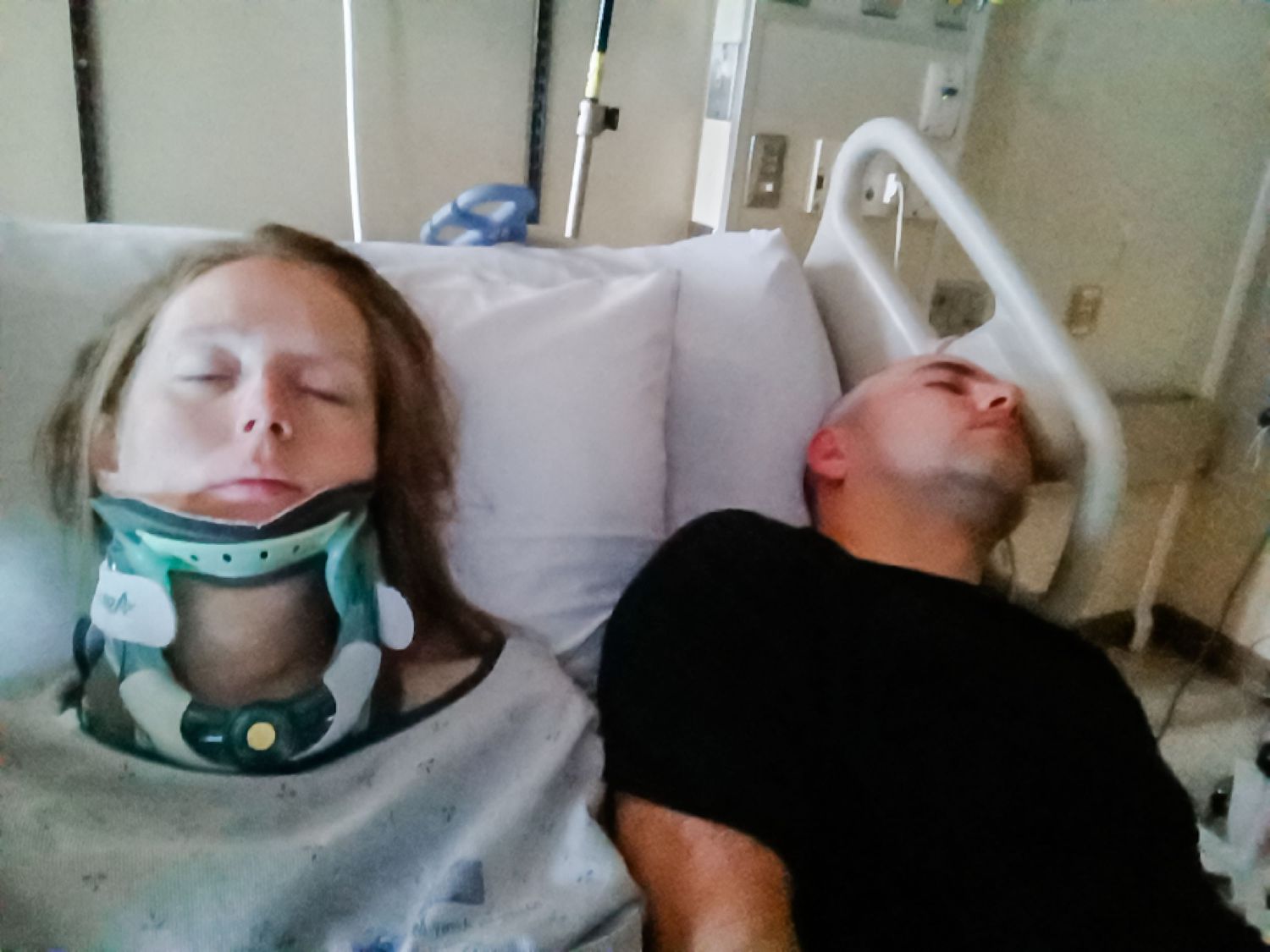 Medical recovery room with patient wearing neck brace.