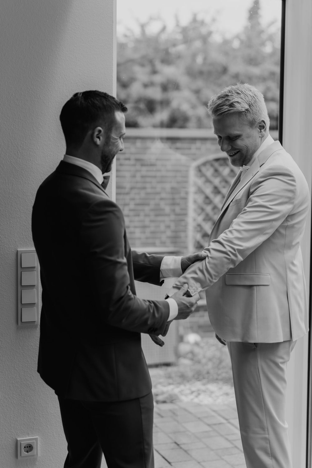 Black and white moment of two people in formal attire sharing a meaningful exchange.