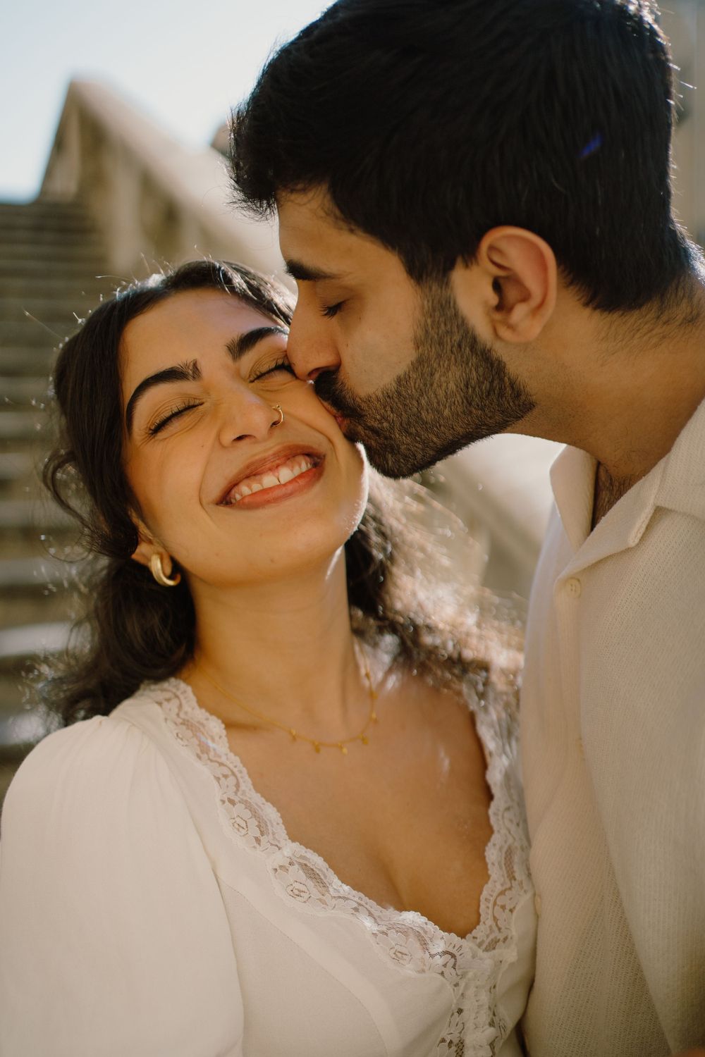Guy giving a kiss on the cheek of her girlfriend in Palermo, captured by a Sicily photographer