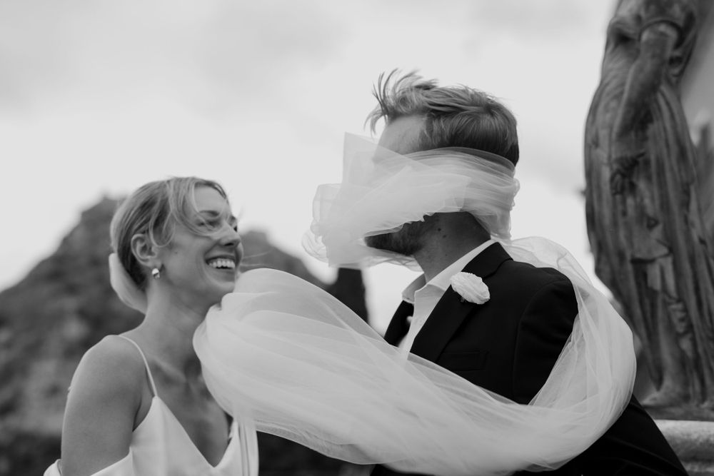 Bride’s veil blowing in the wind during a romantic wedding in Sicily.