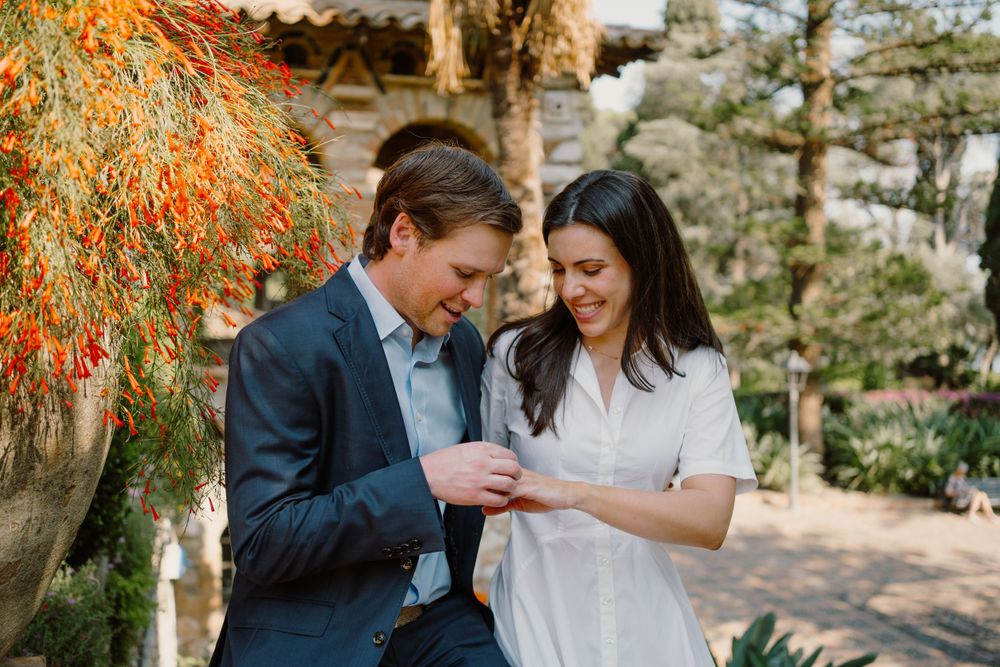 Couple looking at the right after the proposal in Sicily