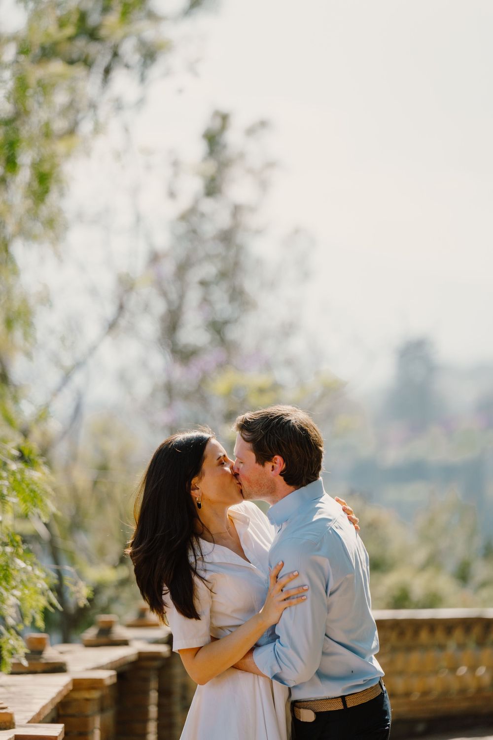 A couple kissing right after a surprise proposal in Italy